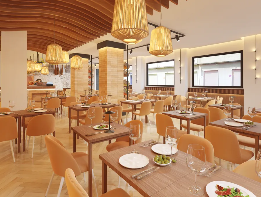 Sala del restaurante con las mesas de madera y las sillas en tono mostaza
